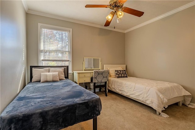 carpeted bedroom with ceiling fan and ornamental molding