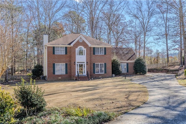 colonial inspired home featuring central AC unit