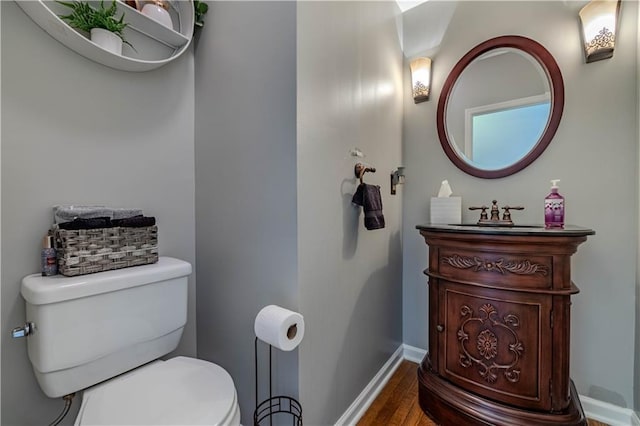 bathroom featuring hardwood / wood-style flooring, vanity, and toilet