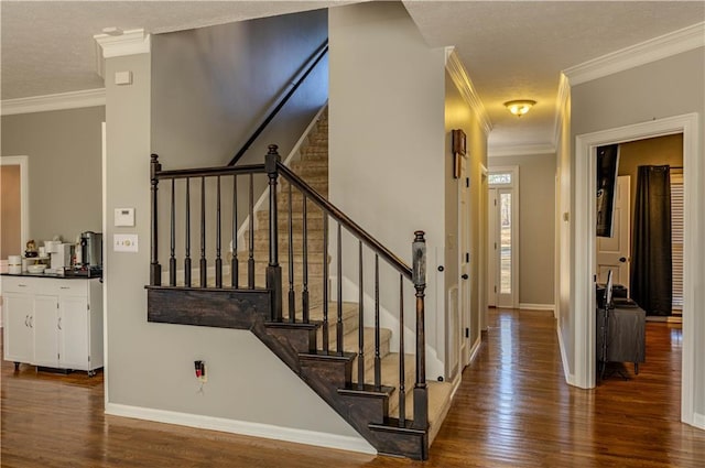 stairway with hardwood / wood-style flooring and crown molding