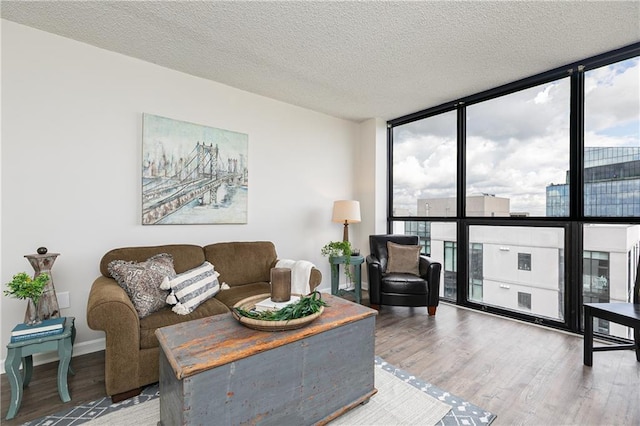 living area featuring expansive windows, wood finished floors, and a textured ceiling