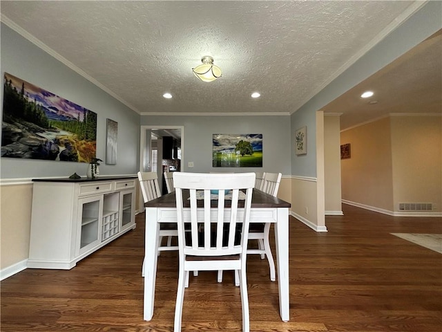 5862 Kitchens Rd SE, Mableton, GA 30126 - dining area featuring dark wood-type flooring, ornamental molding, and a textured ceiling