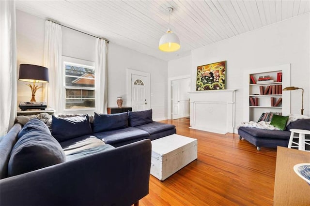 living room featuring light wood finished floors and wooden ceiling