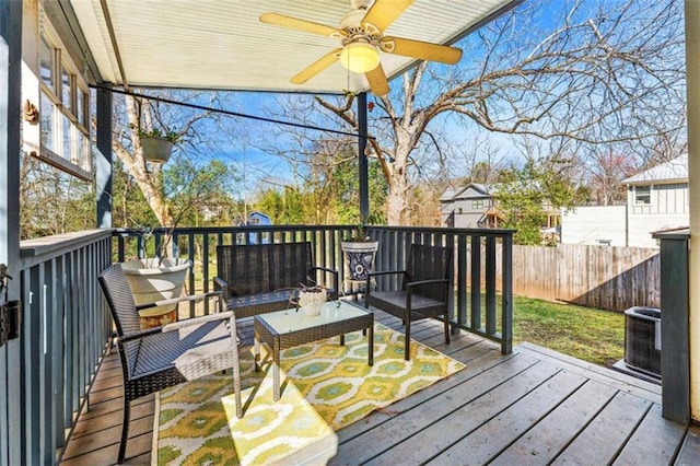 wooden deck featuring a ceiling fan, central AC unit, outdoor lounge area, and fence