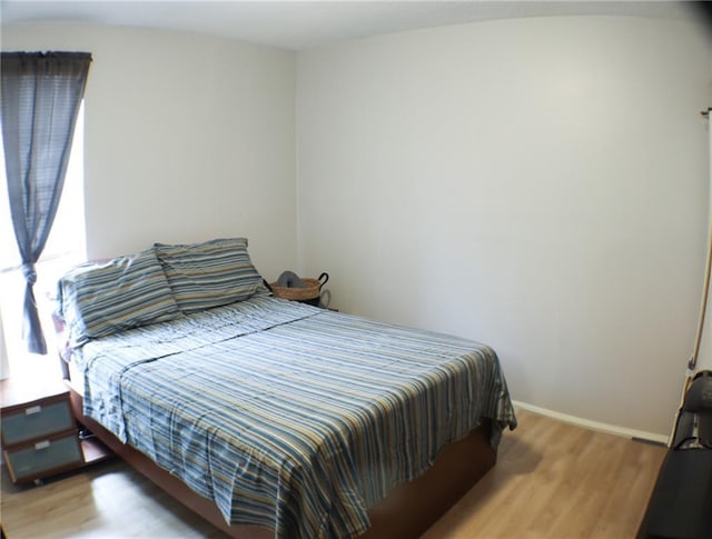 bedroom with hardwood / wood-style flooring