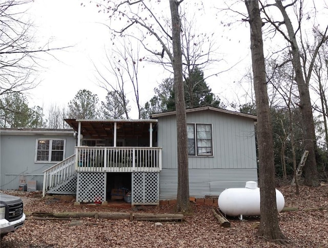 rear view of house with a wooden deck