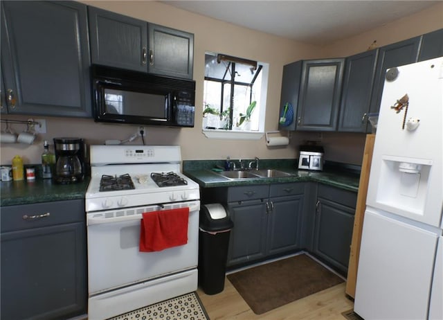 kitchen featuring white appliances, sink, light hardwood / wood-style flooring, and gray cabinetry