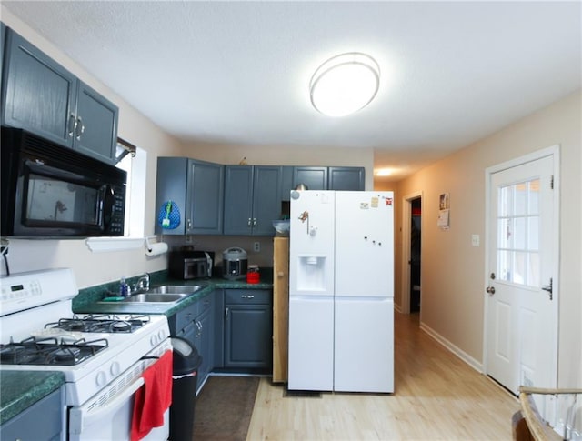 kitchen featuring sink, white appliances, and light wood-type flooring