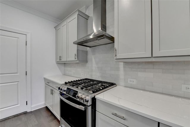 kitchen featuring light stone countertops, backsplash, ornamental molding, wall chimney exhaust hood, and stainless steel gas stove