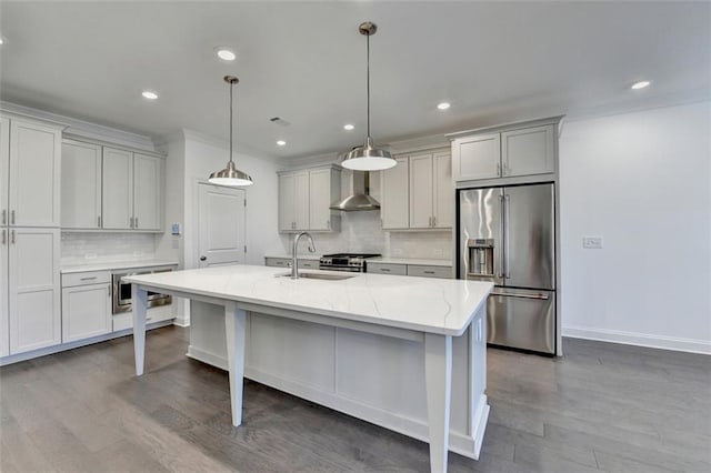 kitchen featuring light stone counters, stainless steel appliances, a kitchen island with sink, sink, and pendant lighting