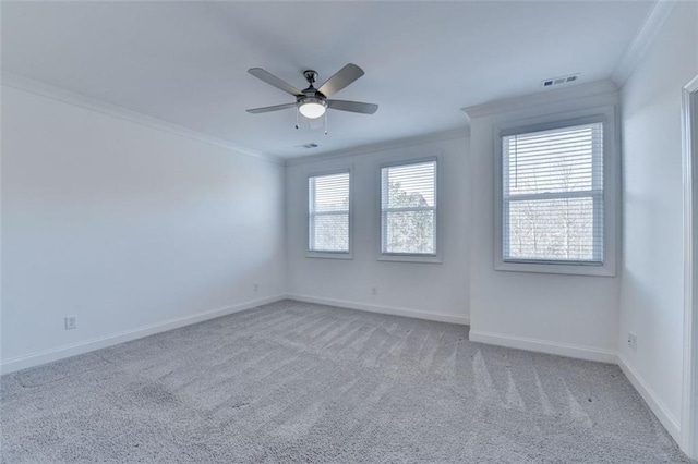 carpeted spare room featuring crown molding and ceiling fan