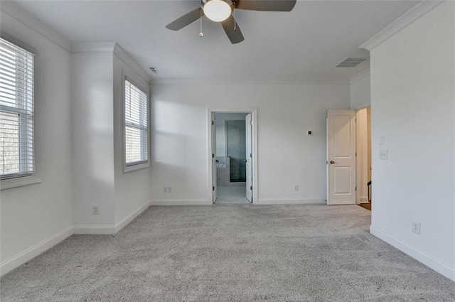 spare room with a healthy amount of sunlight, ceiling fan, light carpet, and ornamental molding