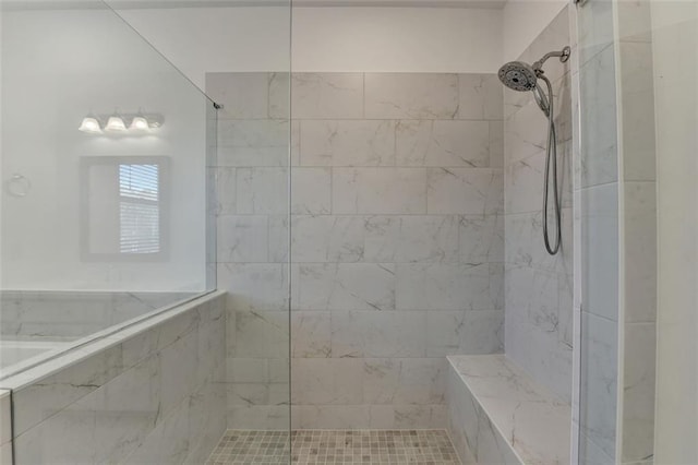 bathroom with tiled shower