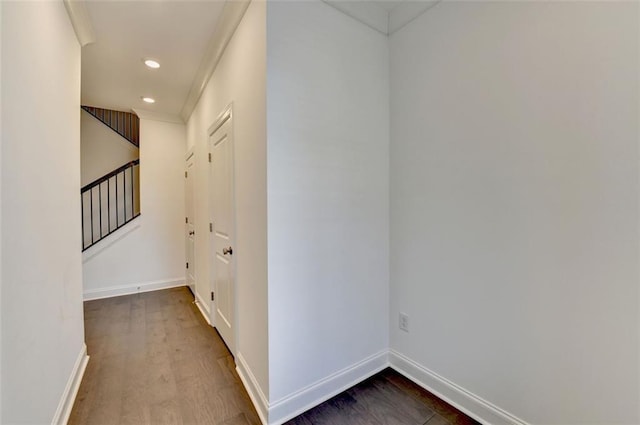 corridor featuring hardwood / wood-style flooring and ornamental molding