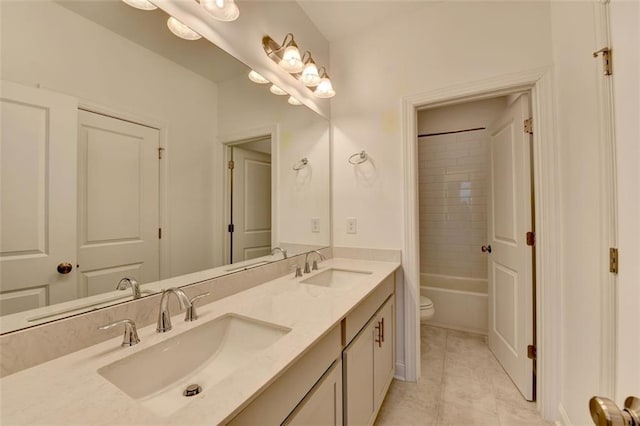 full bathroom with tile patterned flooring, vanity, tiled shower / bath combo, and toilet