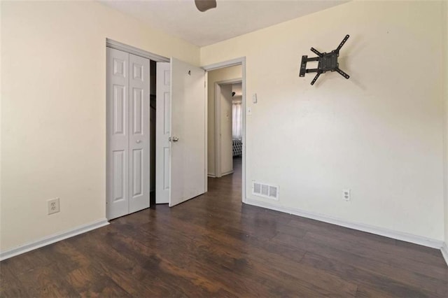 empty room featuring dark wood-type flooring