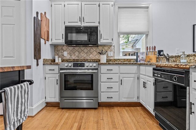 kitchen featuring black appliances, light wood-type flooring, white cabinets, and stone countertops