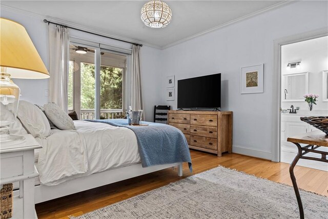 bedroom with ensuite bath, ornamental molding, and light hardwood / wood-style floors