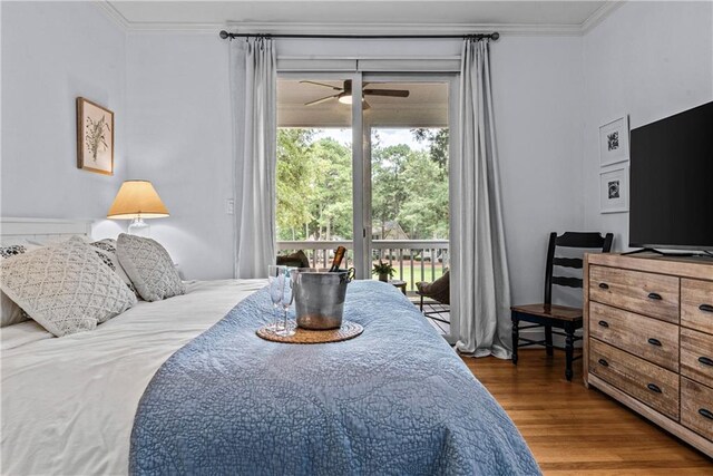 bedroom featuring ornamental molding, hardwood / wood-style floors, and access to exterior