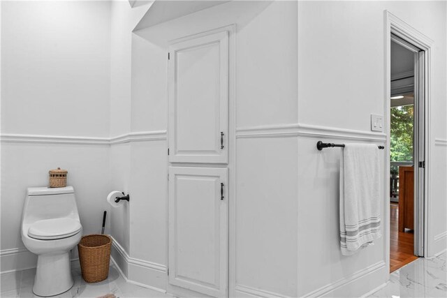 bathroom featuring hardwood / wood-style floors and toilet