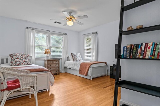 bedroom with light wood-type flooring and ceiling fan