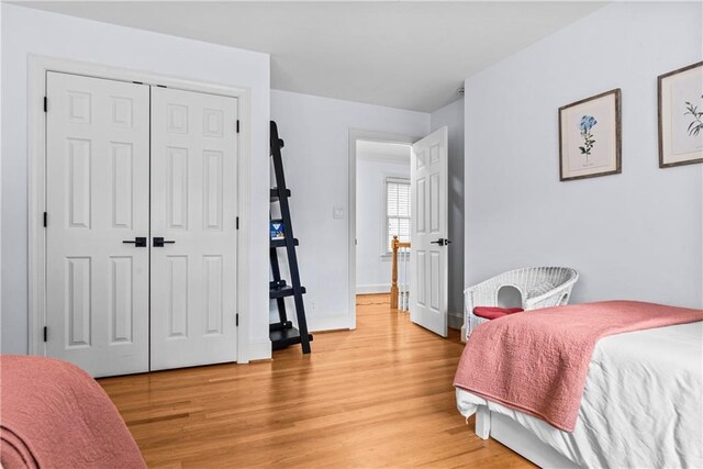 bedroom featuring light wood-type flooring and a closet