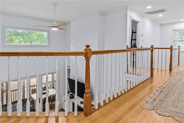 stairway featuring ornamental molding and hardwood / wood-style flooring