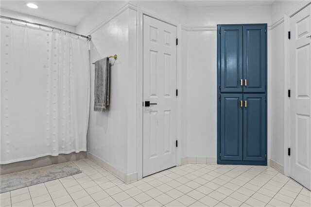 bathroom with tile patterned flooring and curtained shower