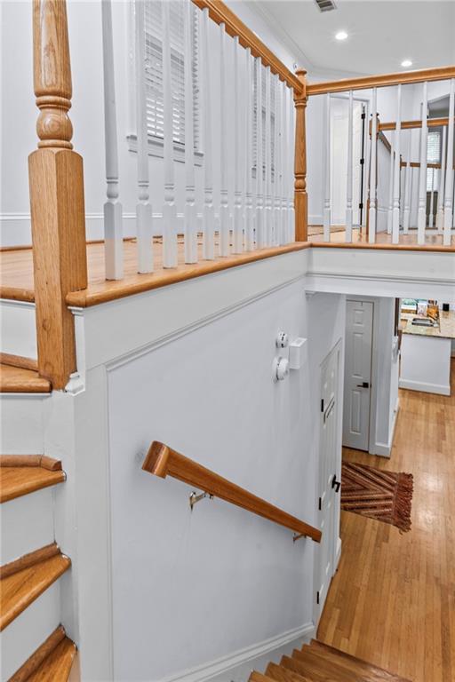 stairway with hardwood / wood-style flooring