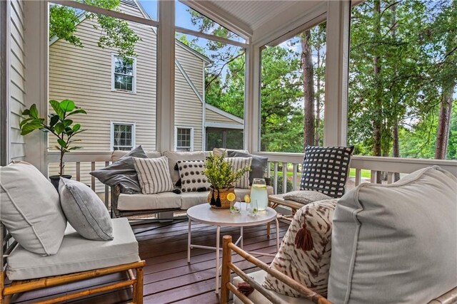 sunroom featuring vaulted ceiling