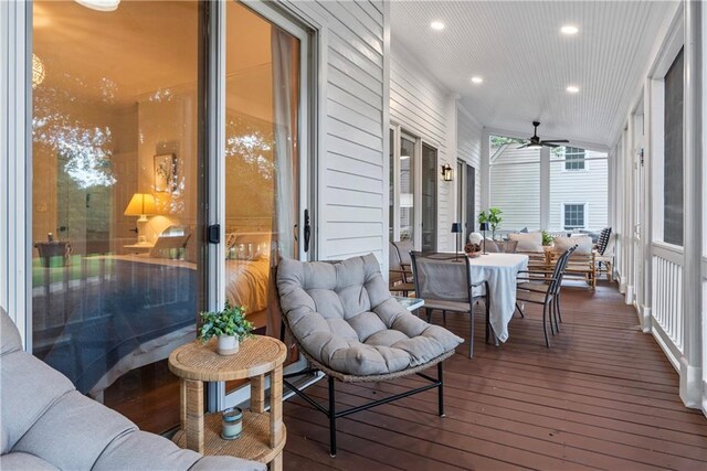 deck featuring an outdoor living space and ceiling fan