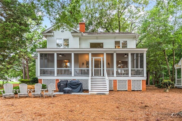 back of house with ceiling fan and a sunroom