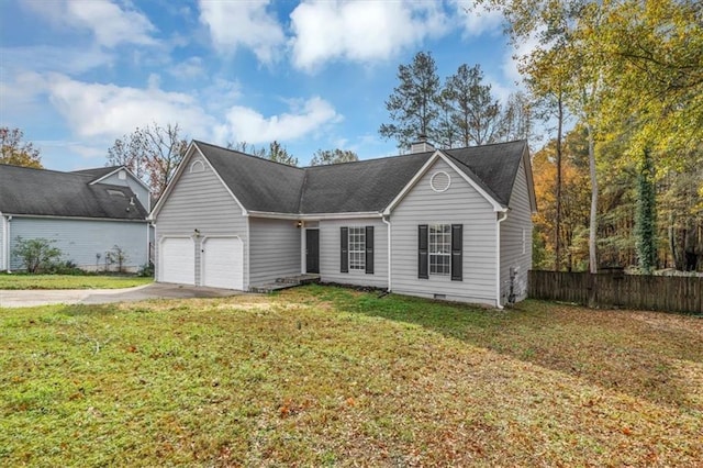 view of front of property with a garage and a front lawn