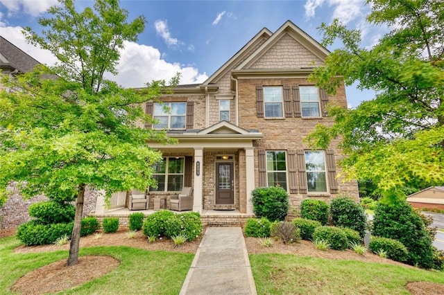 4895 Sterling Close, Buford, GA 30518 - view of front of home featuring covered porch, stone siding, and a front lawn