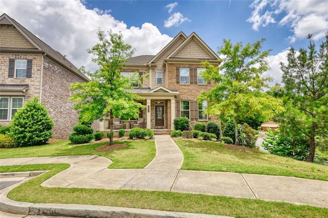 4895 Sterling Close, Buford, GA 30518 - view of front of home featuring a front yard, a porch, and stone siding