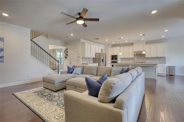 4895 Sterling Close, Buford, GA 30518 - living area with dark wood-type flooring, stairs, ceiling fan, recessed lighting, and crown molding
