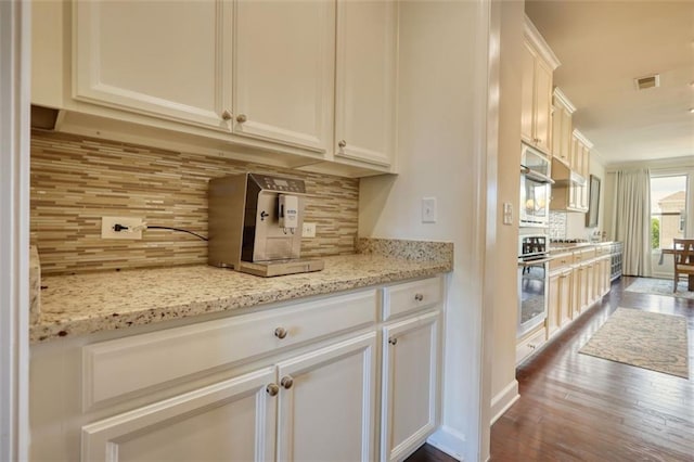 4895 Sterling Close, Buford, GA 30518 - kitchen featuring backsplash, dark wood-type flooring, light stone counters, and white cabinetry