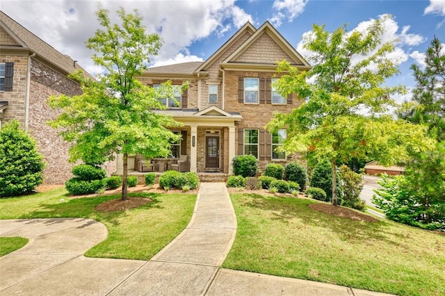 4895 Sterling Close, Buford, GA 30518 - view of front facade with covered porch, a front lawn, stone siding, and brick siding