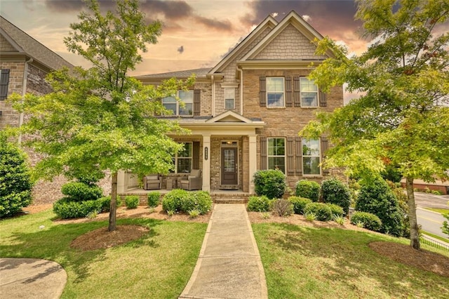 4895 Sterling Close, Buford, GA 30518 - view of front of property featuring a front yard, stone siding, and a porch