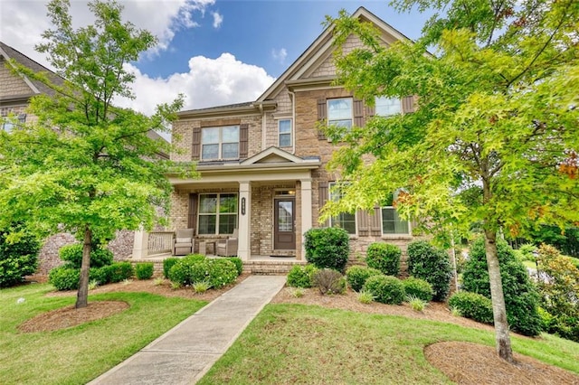 4895 Sterling Close, Buford, GA 30518 - view of front of property featuring covered porch, a front lawn, brick siding, and stone siding