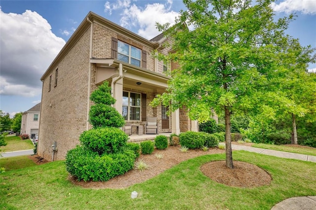 4895 Sterling Close, Buford, GA 30518 - view of front of property featuring brick siding, covered porch, and a front yard