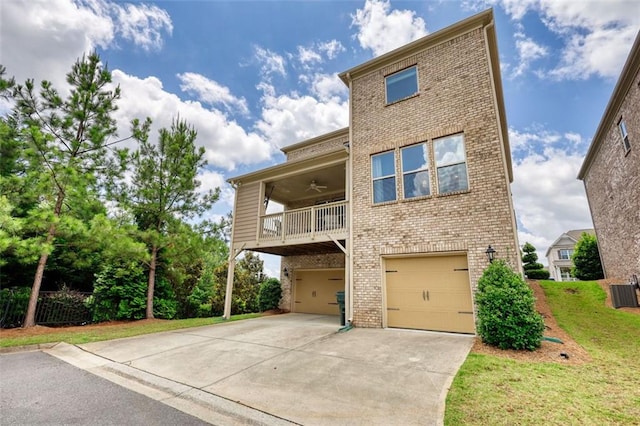 4895 Sterling Close, Buford, GA 30518 - view of front of house with brick siding, an attached garage, driveway, ceiling fan, and a balcony