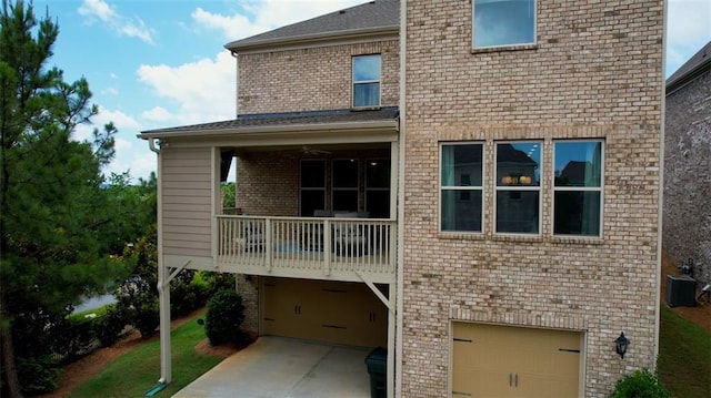 4895 Sterling Close, Buford, GA 30518 - back of house with a garage, a balcony, brick siding, and a yard