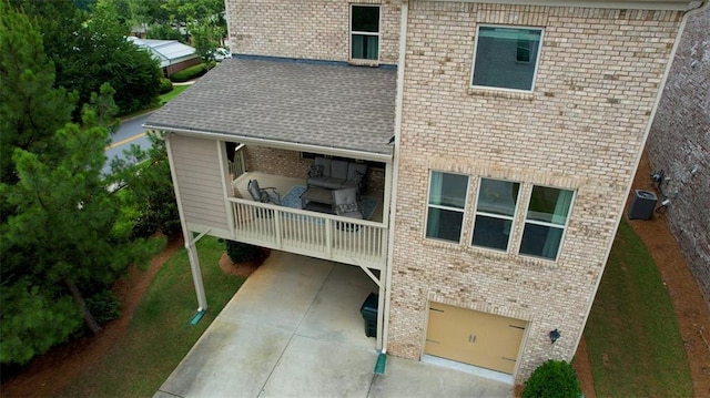 4895 Sterling Close, Buford, GA 30518 - back of house featuring brick siding, an attached garage, a shingled roof, and driveway