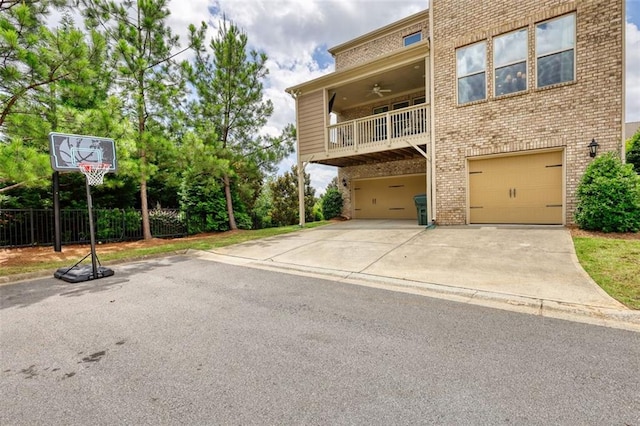 4895 Sterling Close, Buford, GA 30518 - view of front of home with an attached garage, brick siding, ceiling fan, driveway, and a balcony