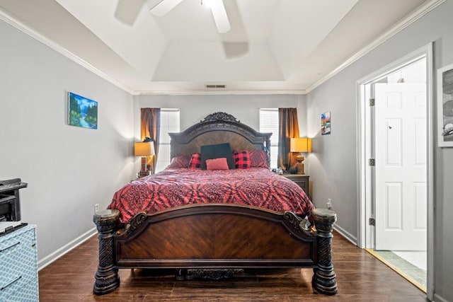 bedroom featuring visible vents, baseboards, a raised ceiling, and wood finished floors