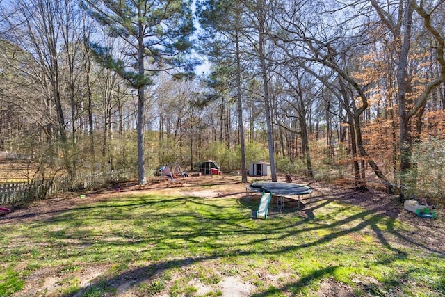 view of yard featuring an outbuilding and a view of trees