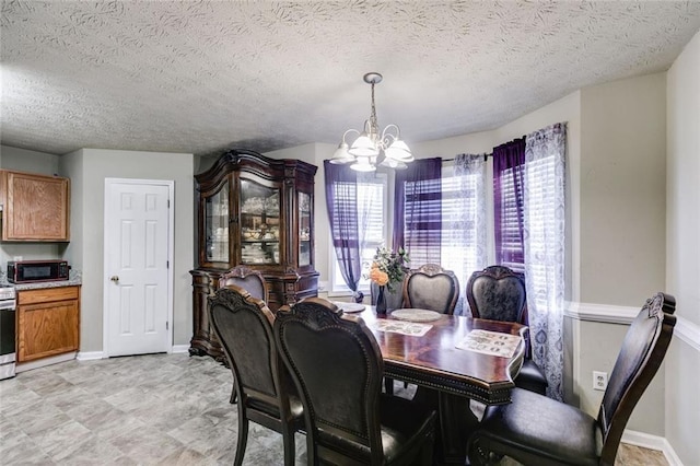 674 Fairview Dr, Dallas, GA 30157 - dining space featuring a chandelier, a textured ceiling, and baseboards