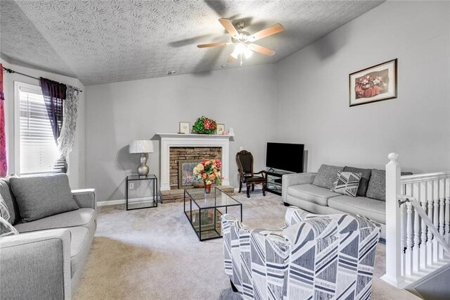 674 Fairview Dr, Dallas, GA 30157 - living area featuring a stone fireplace, light carpet, a ceiling fan, a textured ceiling, and lofted ceiling