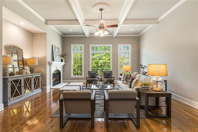 living room featuring coffered ceiling, dark hardwood / wood-style floors, ceiling fan, beamed ceiling, and crown molding